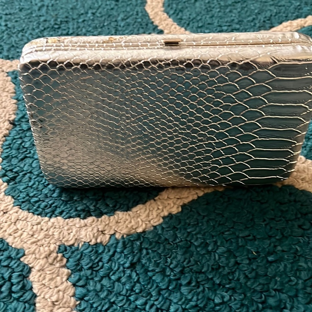 Cute silver clutch holds a lot of items! Staple in my closet :) mild scuffs